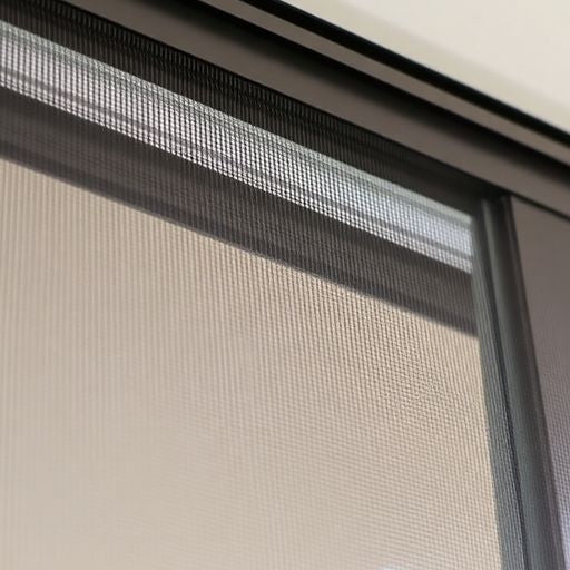 Close-up of a window with a screen installed.