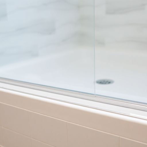 Close-up of a new shower door bottom seal.