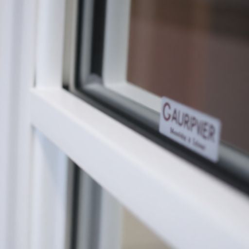 Close-up of a window frame with manufacturer's logo.