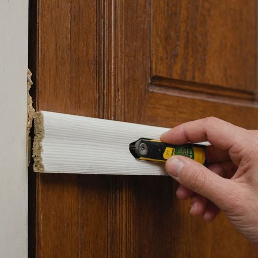 Applying weatherstripping to a wooden door