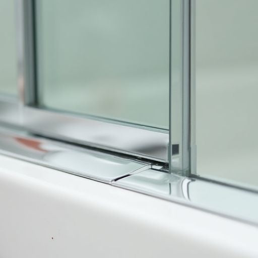 Hand installing a clear shower door sweep.