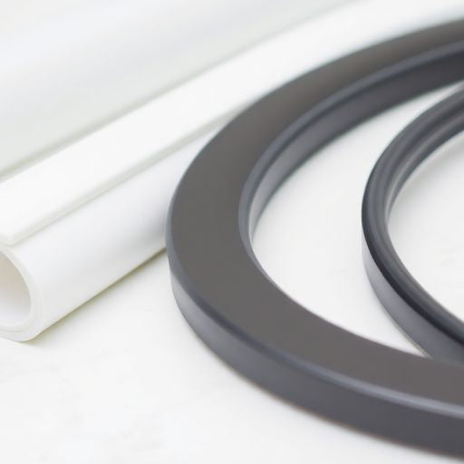 Variety of shower door gaskets on a plain background.